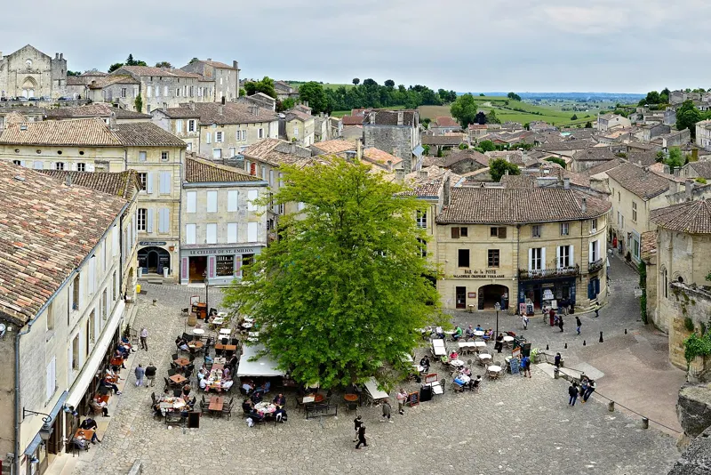 Saint-Émilion’s main square — where walking tours pause for a café stop